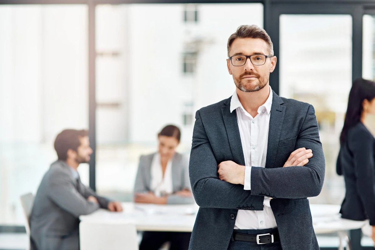 a photo ID captures the back of my team, featuring a portrait of a businessman in the office with his colleagues in the background.