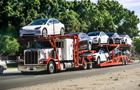 A truck transporting multiple cars on its bed.