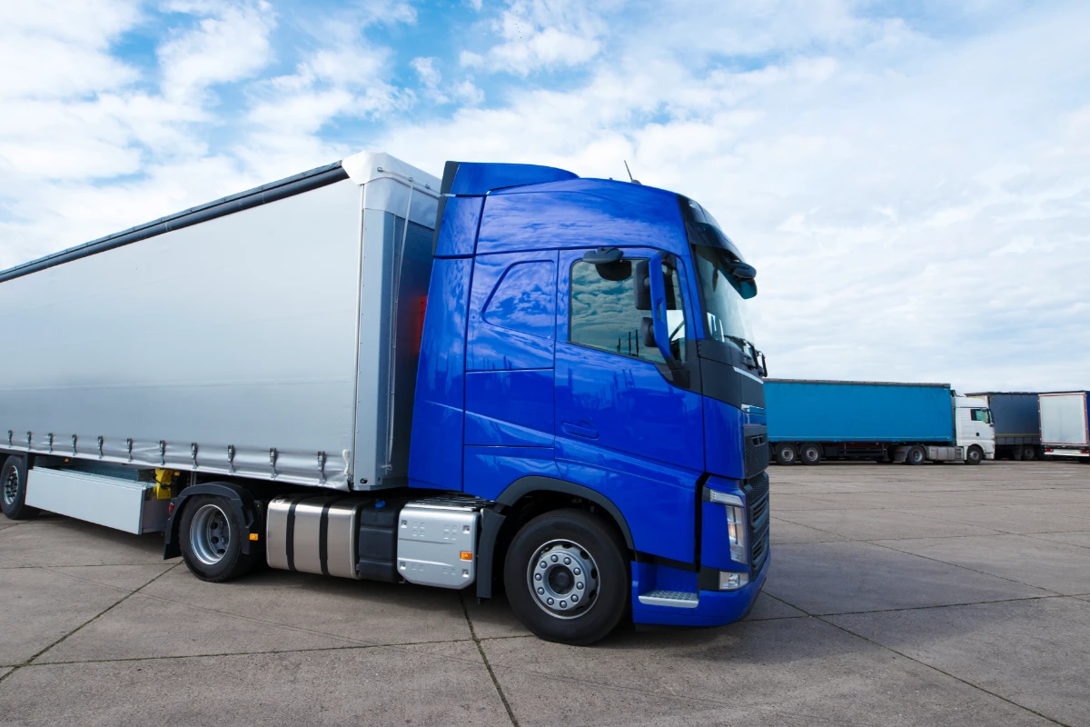 A parked blue truck in a parking lot.