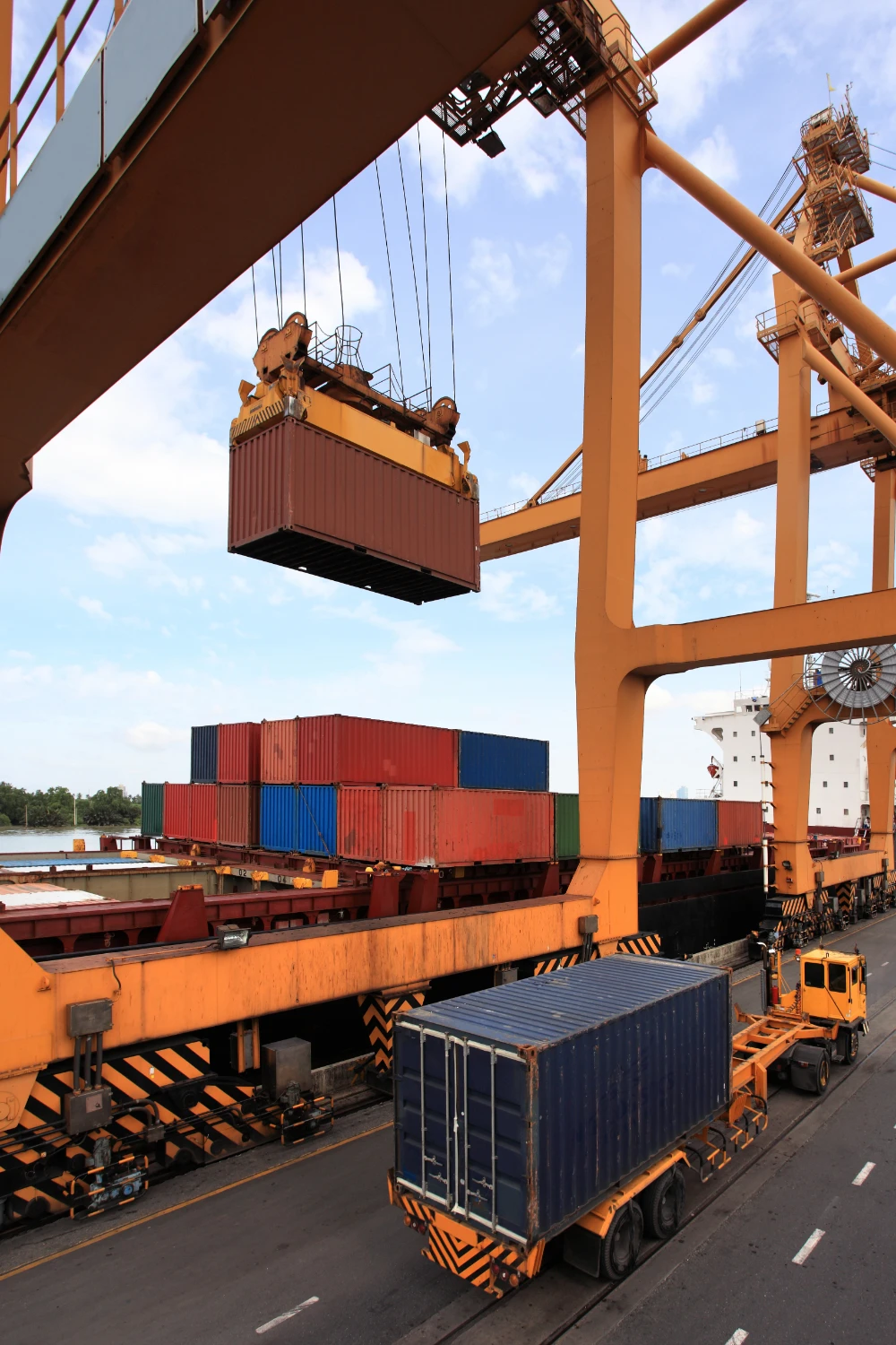 A crane hoisting cargo onto a truck, showcasing efficient transportation of goods.